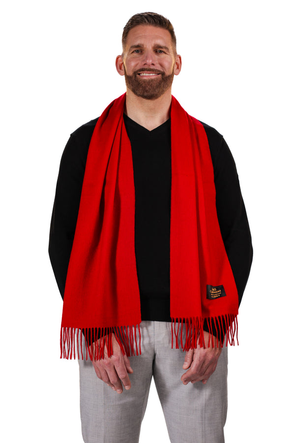 Ruby Echo lambswool scarf worn by model, featuring a bold solid red color, soft texture, and long fringed edges for a classic, statement look