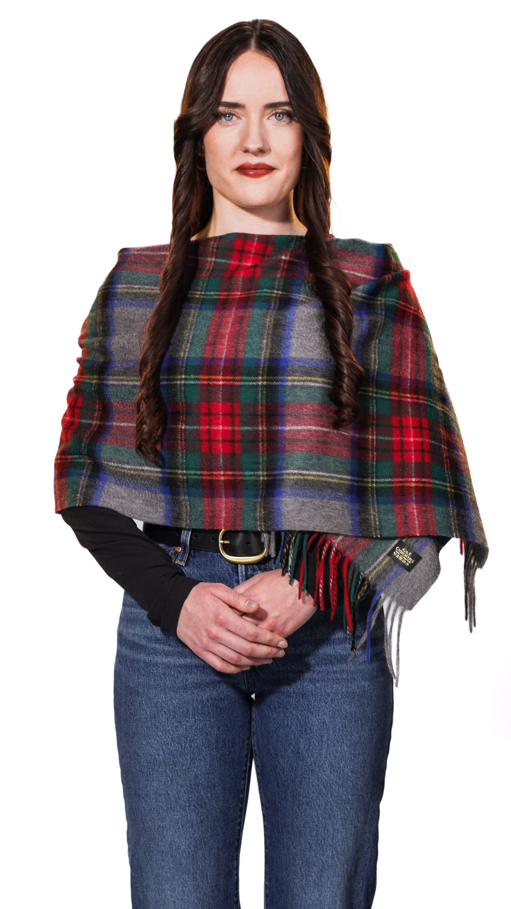 Model wearing Sterling Veil cashmere stole in a multicolor tartan plaid featuring red, deep green, navy blue, and grey 