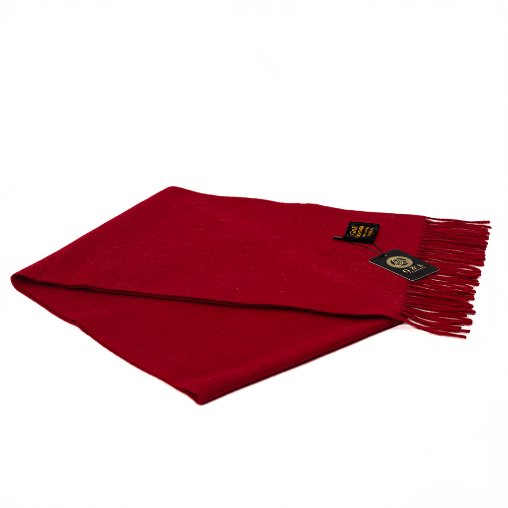 Cardinal Vale lambswool scarf in solid deep red, featuring a smooth soft finish, fine fringe edges, and subtle branding tag, displayed folded on a white background