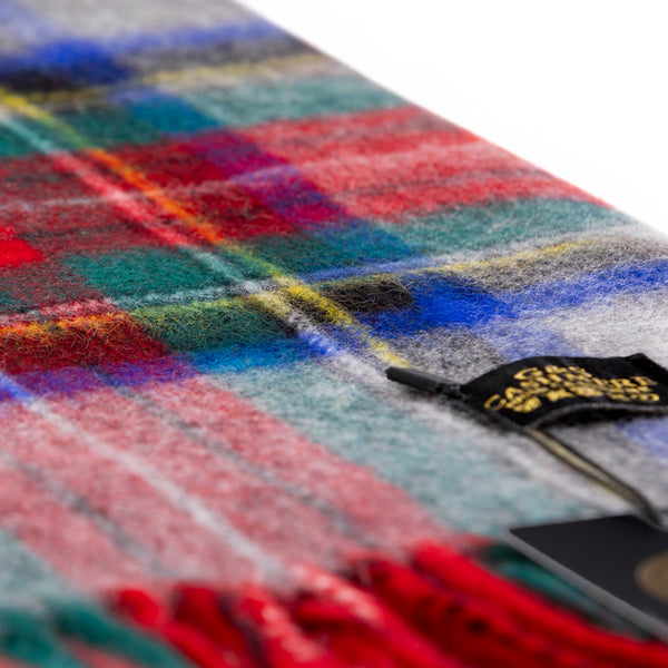 Close-up of Sterling Veil cashmere stole in multicolor tartan plaid featuring red, deep green, navy blue, and grey, with fine woven texture 