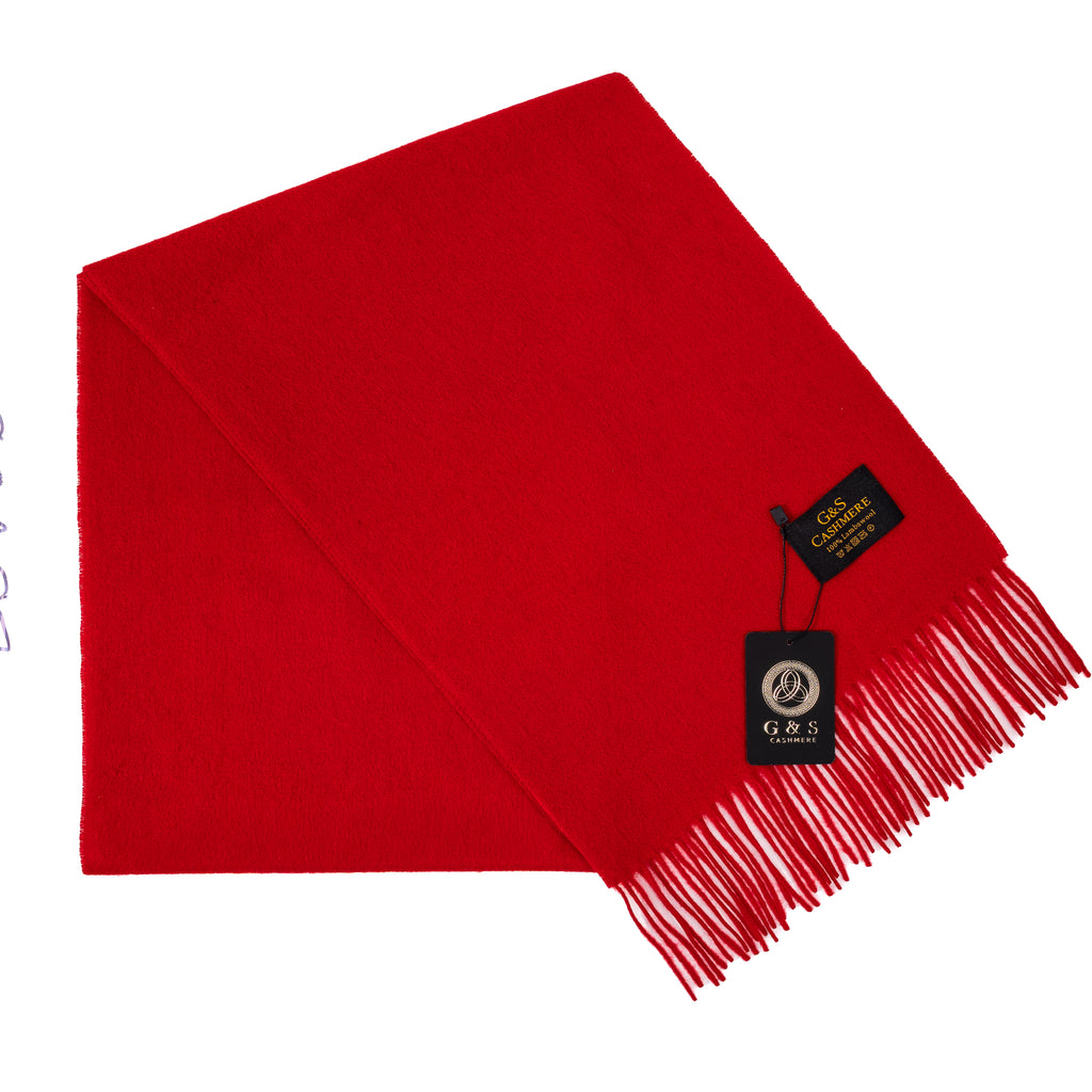 Close-up of Ruby Echo lambswool scarf highlighting vibrant red fabric, soft finish, fine fringe detailing, and branded tag for a premium luxury feel