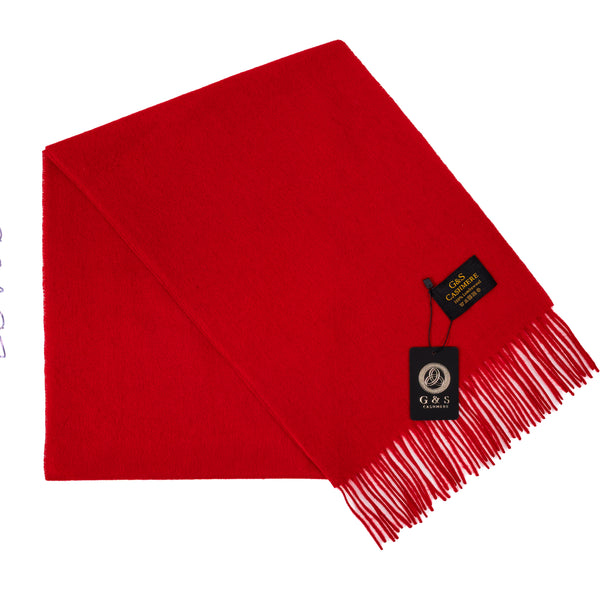 Close-up of Ruby Echo lambswool scarf highlighting vibrant red fabric, soft finish, fine fringe detailing, and branded tag for a premium luxury feel